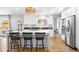 Modern kitchen with white cabinets, stainless steel appliances, a large island, and a window above the sink at 3206 S Clayton St, Denver, CO 80210
