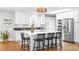 Modern kitchen with white cabinets, stainless steel appliances, and a large center island with seating at 3206 S Clayton St, Denver, CO 80210