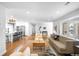 Open-concept living room with hardwood floors connecting to a kitchen with stainless steel appliances at 3206 S Clayton St, Denver, CO 80210