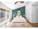 Serene main bedroom features a statement wall, neutral decor, and large windows offering ample natural light at 3206 S Clayton St, Denver, CO 80210