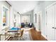 Inviting home office space boasts hardwood floors, lots of natural light, and comfortable seating at 3206 S Clayton St, Denver, CO 80210