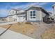 Modern house with gray stone and siding, complemented by a neatly landscaped front yard at 24719 E 39Th Ave, Aurora, CO 80019