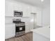 Modern kitchen features stainless steel appliances, white cabinetry, and stone countertops at 24719 E 39Th Ave, Aurora, CO 80019