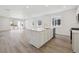 Bright open concept kitchen with white island, modern appliances, and natural light at 24719 E 39Th Ave, Aurora, CO 80019