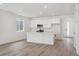 Bright and airy kitchen featuring white cabinetry, hard surface floors and central island at 24719 E 39Th Ave, Aurora, CO 80019