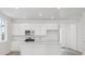 Modern kitchen boasts stainless steel appliances, white cabinets, and island with breakfast bar at 24719 E 39Th Ave, Aurora, CO 80019