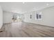 Spacious living room features wood flooring, recessed lighting, and large windows offering ample natural light at 24719 E 39Th Ave, Aurora, CO 80019