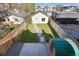 Aerial view of a backyard featuring a green lawn, wooden fence, sauna, and stone path at 3938 Kalamath St, Denver, CO 80211
