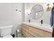 Bright bathroom featuring a dual sink vanity with a wood grain finish and stylish fixtures at 3938 Kalamath St, Denver, CO 80211