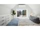 Brightly lit bedroom with large window framing exterior view, complemented by built-in storage at 3938 Kalamath St, Denver, CO 80211