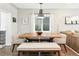 Dining room with a rustic wooden table and bench seating, bathed in natural light at 3938 Kalamath St, Denver, CO 80211