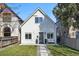 Charming two-story white home with a well-manicured front lawn and inviting curb appeal at 3938 Kalamath St, Denver, CO 80211