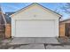 A white garage door with a concrete driveway provides secure parking and storage at 3938 Kalamath St, Denver, CO 80211
