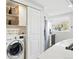 Convenient laundry area off the kitchen with modern washer, dryer, and storage solutions at 3938 Kalamath St, Denver, CO 80211