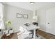 Home office area with a modern desk, stylish decor, natural light, and hardwood flooring at 3938 Kalamath St, Denver, CO 80211