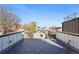 Rooftop deck featuring modern railings and tile flooring, perfect for outdoor gatherings with neighborhood views at 3938 Kalamath St, Denver, CO 80211