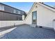 Modern roof deck with gray tile, steps to enter the home, and sleek architecture at 3938 Kalamath St, Denver, CO 80211