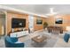 Basement featuring wood paneling, TV, and a foosball table, creating an ideal entertainment and relaxation space at 3790 W 54Th Ave, Denver, CO 80221