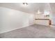 Spacious basement with neutral carpet and a built-in bar area, offering potential for entertainment or recreation at 3790 W 54Th Ave, Denver, CO 80221