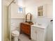 Bathroom featuring classic black and white tile, vintage vanity, and shower, offering a charming, functional space at 3790 W 54Th Ave, Denver, CO 80221