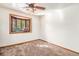 Bright bedroom with a bay window offering natural light, neutral carpet, and a ceiling fan at 3790 W 54Th Ave, Denver, CO 80221