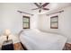 Cozy bedroom with two shuttered windows, ceiling fan, and neutral decor offering a serene space at 3790 W 54Th Ave, Denver, CO 80221