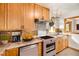 Cozy kitchen with wooden cabinets, stainless steel appliances, and a functional layout at 3790 W 54Th Ave, Denver, CO 80221