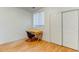 Bedroom with wood floor, window, and built-in desk at 9861 E Carolina Pl, Aurora, CO 80247