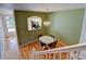 Open dining area with modern chandelier adjacent to kitchen view through archway at 9861 E Carolina Pl, Aurora, CO 80247