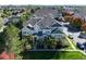 Three-story townhome with gray roof, landscaping, and walkway at 9861 E Carolina Pl, Aurora, CO 80247