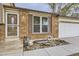 Close-up of the home's entrance, showcasing the brick detail, front door, and manicured landscaping at 5241 E 111Th Ct, Thornton, CO 80233