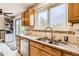 Kitchen sink area featuring granite countertops, modern faucet, and natural light from the window at 5241 E 111 Th Ct, Thornton, CO 80233