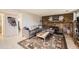 Inviting living room showcasing a brick fireplace, wooden coffee table and patterned rug at 5241 E 111 Th Ct, Thornton, CO 80233