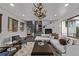Bright living room with modern decor, fireplace, spiral staircase and antler chandelier at 11987 W Ranch Elsie Rd, Golden, CO 80403
