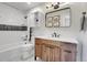 Charming bathroom with a modern vanity, tub and shower combo, and fun dinosaur prints at 1692 Sand Lily Dr, Golden, CO 80401