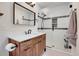 Stylish bathroom featuring a glass enclosed shower and a wood vanity at 1692 Sand Lily Dr, Golden, CO 80401