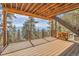 Spacious wood deck offers stunning mountain views, metal railings, and stairs to access this home's natural surroundings at 1692 Sand Lily Dr, Golden, CO 80401