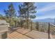 Open wood deck with mountain views, horizontal metal railings, and a gas grill at 1692 Sand Lily Dr, Golden, CO 80401