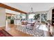 Open dining room area with large windows showcasing the mountain view and hardwood flooring at 1692 Sand Lily Dr, Golden, CO 80401