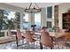 Dining room features a modern chandelier, wooden table, and amazing mountain views at 1692 Sand Lily Dr, Golden, CO 80401