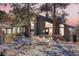 Beautiful home featuring large windows, modern architecture, rock outcroppings, and updated outdoor lighting at 1692 Sand Lily Dr, Golden, CO 80401