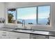 Kitchen area with stainless steel appliances, modern countertops, and large window with mountain views at 1692 Sand Lily Dr, Golden, CO 80401