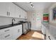 Well-lit laundry room with white cabinetry, stainless steel washer and dryer at 1692 Sand Lily Dr, Golden, CO 80401