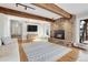 Spacious living room with wood floors, stone fireplace, and rustic wood beam accents at 1692 Sand Lily Dr, Golden, CO 80401