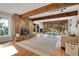 Inviting living room featuring a stone fireplace, wood beams, and natural light at 1692 Sand Lily Dr, Golden, CO 80401