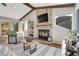 Cozy living room showcasing a stone fireplace, wood mantel, and natural lighting at 1692 Sand Lily Dr, Golden, CO 80401