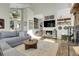 Open concept living room featuring hardwood floors, fireplace, high ceilings, and staircase at 1692 Sand Lily Dr, Golden, CO 80401