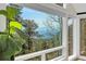 Stunning mountain views from the windows, framed by lush greenery and plants at 1692 Sand Lily Dr, Golden, CO 80401