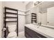 The bathroom includes a toilet, vanity, mirror, shelving, and walk-in shower at 7440 S Blackhawk St # 15-202, Englewood, CO 80112