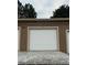 Single car garage with white door nestled in the community at 7440 S Blackhawk St # 15-202, Englewood, CO 80112